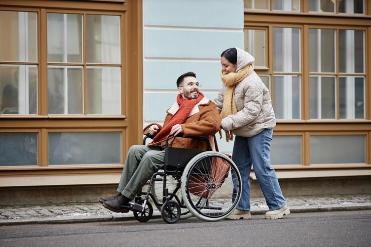 smiling-young-woman-assisting-man-wheelchair-date-together-city-streets